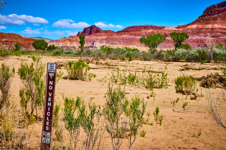 No Vehicles Sign with Red Rock Formations and Desert Vegetation in Paria Utahの写真素材
