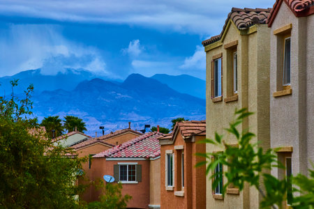 Suburban Las Vegas Homes with Stormy Mountains and Lush Greeneryの写真素材
