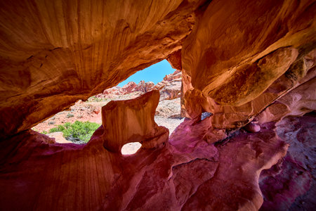 Sandstone Arch Formation with Window View and Eroded Rock Layersの写真素材