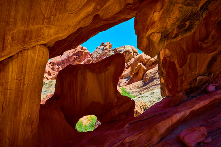Red Rock Arch Formation With Double Openings In Desert Landscapeの写真素材
