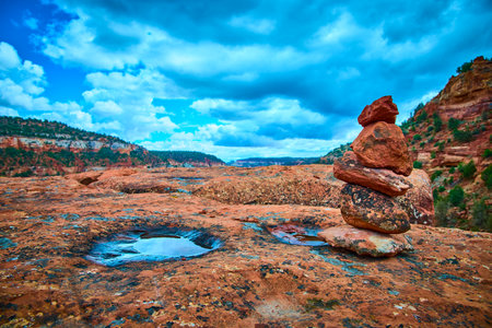 Red Rock Cairn on Rugged Plateau with Reflections Sedona Wildernessの写真素材