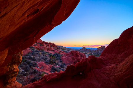 Red Rock Arch Formation Framing Desert Landscape at Sunsetの写真素材