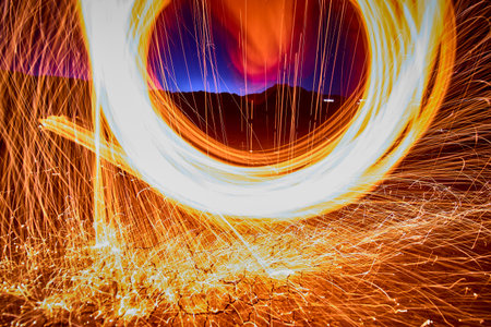 Steel Wool Sparks Swirling Over Desert Ground at Golden Hour in Nevadaの写真素材