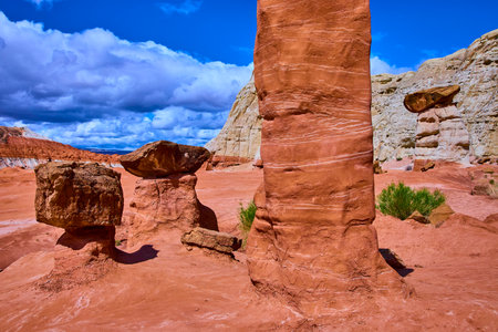 Toadstool Hoodoos and Layered Cliffs under Dramatic Clouds in Utah Desertの写真素材