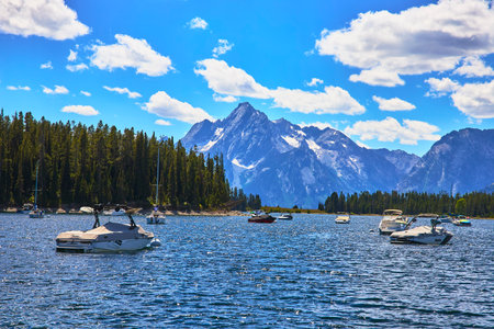 Boats on Jackson Lake with Grand Teton Mountain and Forest Marina Water View