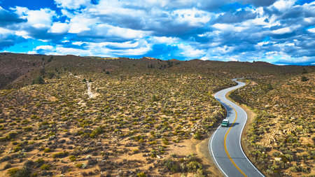 Aerial Winding Road Through Desert Landscape and Vehicle in Eastern Sierra California