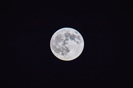 Full Moon at Night with Detailed Surface Texture Against Black Sky