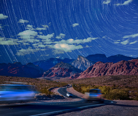 Red Rock Canyon Night Road with Cars Under Star Trails and Turtlehead Peak Nevadaの写真素材