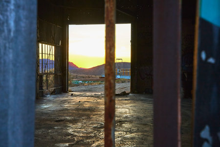Abandoned Mill Interior With Graffiti and Mojave Desert Sunset Californiaの写真素材
