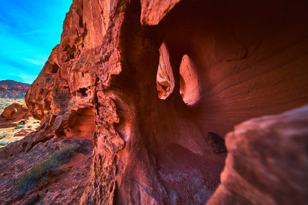 Red Sandstone Formations and Natural Rock Arches in Desert Landscape