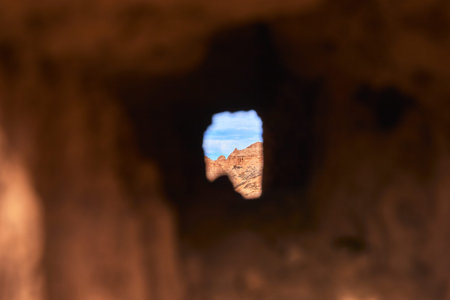 Mysterious Rock Opening Framing Cathedral Gorge Desert Landscape and Blue Sky