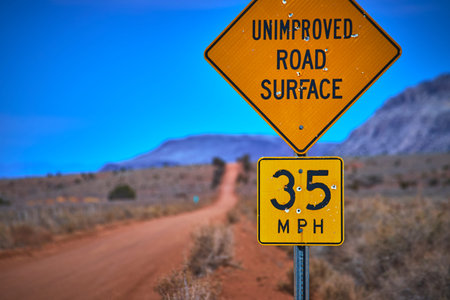 Rural Arizona Unimproved Road Sign with Bullet Holes and Desert Landscape