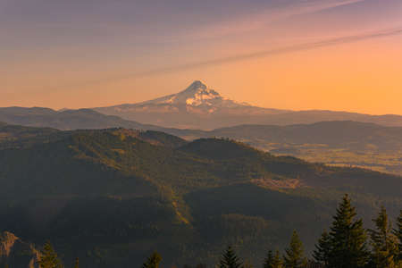 Beautiful rare view of Mt. Hood, Oregon, and surrounding wilderness at golden hour sunset