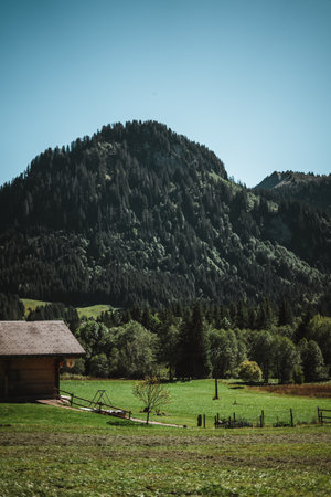 Wooden hut in the alps with mountains in the background Panoramaの写真素材