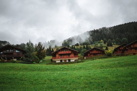 Wooden hut in the alps with mountains in the background Panoramaのeditorial素材