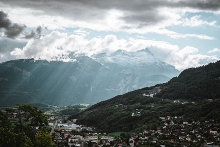 Majestic mountains in the Alps covered with trees and cloudsの写真素材
