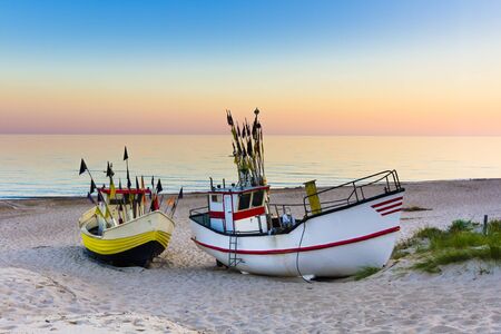 Fishing boat at sunriseの写真素材