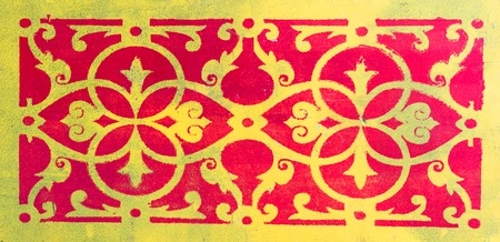close-up. old red yellow ornament on a wooden cutting boardの写真素材