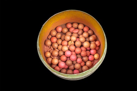 colored balls cosmetic powder on a black background close-upの写真素材