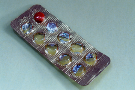 empty packaging of tablets is one tablet Brown blue background