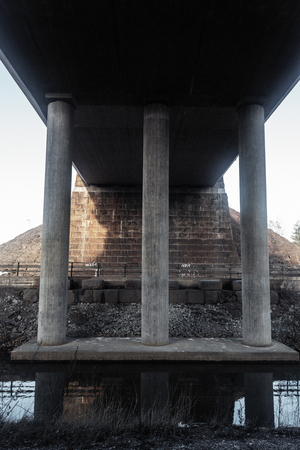 concrete bridge columns, the reflection in the river dayの写真素材