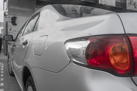 broken tail light on gray carの写真素材
