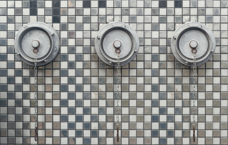 fire hydrants on the wall with mirrored mosaicsの写真素材