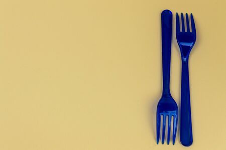 two blue forks lie in the background close up. Place for writingの写真素材