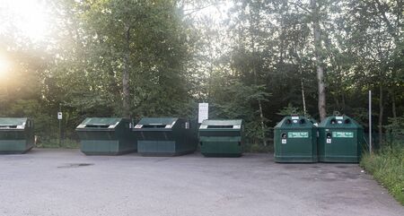 iron dumpsters stand on a site near the forestの写真素材