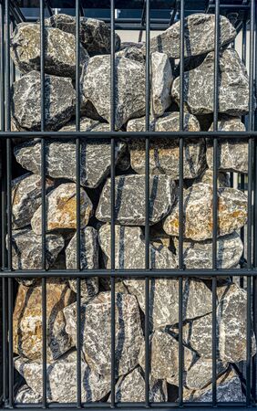 stone fence, iron mesh, large stones for the fenceの写真素材