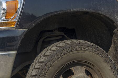 front of the SUV, wheel, suspension, car wing closeup
