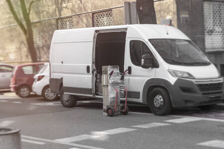 delivery of goods, unloading boxes from the minibusのeditorial素材