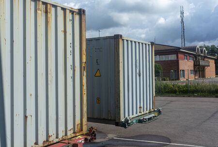 iron containers to transport goods against dark sky