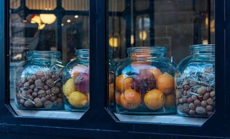 jars with decorative fruits and nuts close upの写真素材