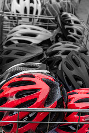 sale of bicycle helmets of different colors. bicycle helmet in the basketの写真素材
