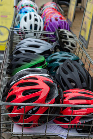 Denmark, Stubbekbing, 21.02.2019: sale of bicycle helmets of different colors. bicycle helmet in the basketのeditorial素材