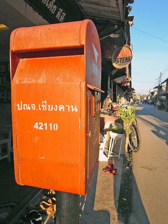 Red post box beside the rural road.のeditorial素材