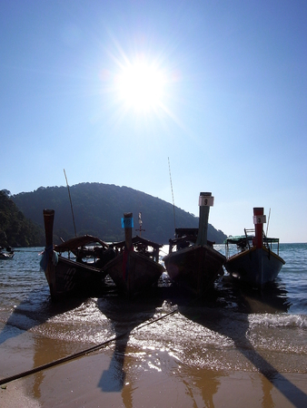 Wooden boat park on the beach, four boats.の写真素材
