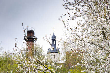 dark chimney vs. white churchの写真素材