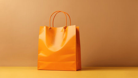 Orange shopping bag on an orange background. Place for text.の素材