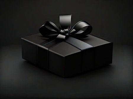 Black gift close-up on a dark background.の素材