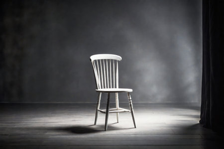 A white chair standing in an empty room against a blank wallの素材
