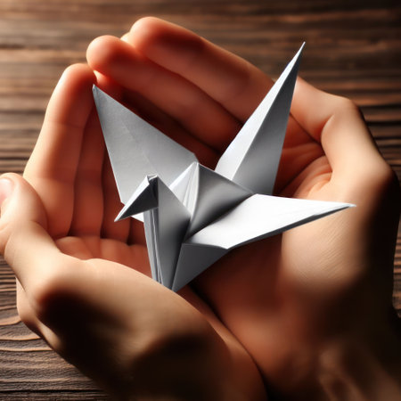 Beautiful white bird made of paper in the palm of your handの素材