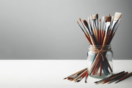 Paint brushes in a glass jar. Space for textの素材