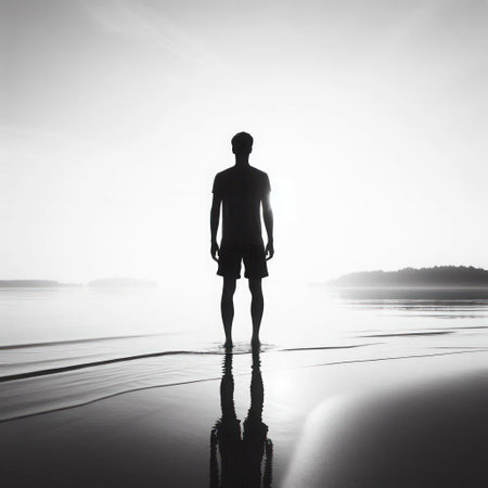 Silhouette of a man standing on the shoreの素材