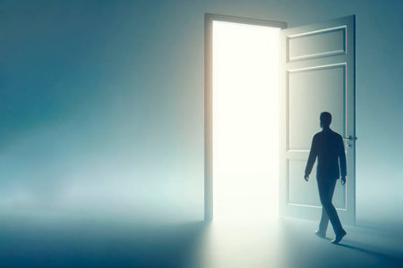 A man at the open door leading into the light. Space for textの素材