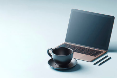 A black cup of coffee next to a laptop. Space for textの素材
