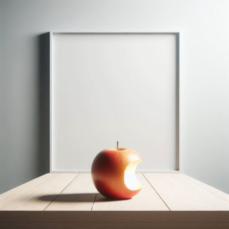 An apple with a bitten edge on a wooden surfaceの素材