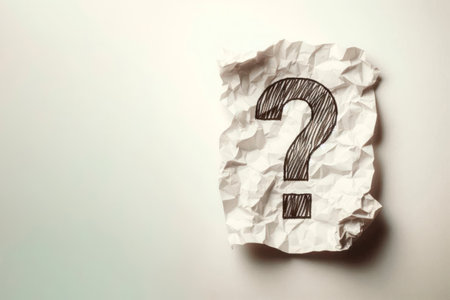 Crumpled paper with a question mark on it. Space for textの素材