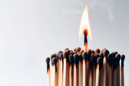 A lit match against the background of a group of other matches. Space for textの素材